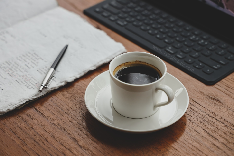 Dallas Maids -Organizing Cleaning Schedule With Cup of Coffee