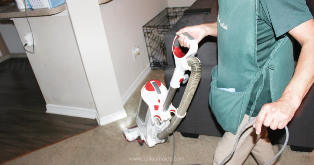 Dallas Maids cleaner vacuuming a living room